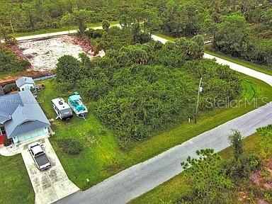 An aerial view shows a house, a camper, a boat, and a vacant wooded lot — 4137 CHIPPEWA STREET, PORT CHARLOTTE, FL