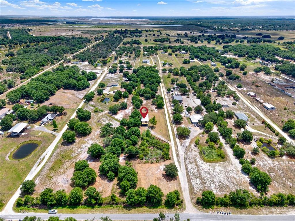 An aerial view shows a house with a red location pin on a rural lot — 464 LOGUE ROAD, MYAKKA CITY, FL