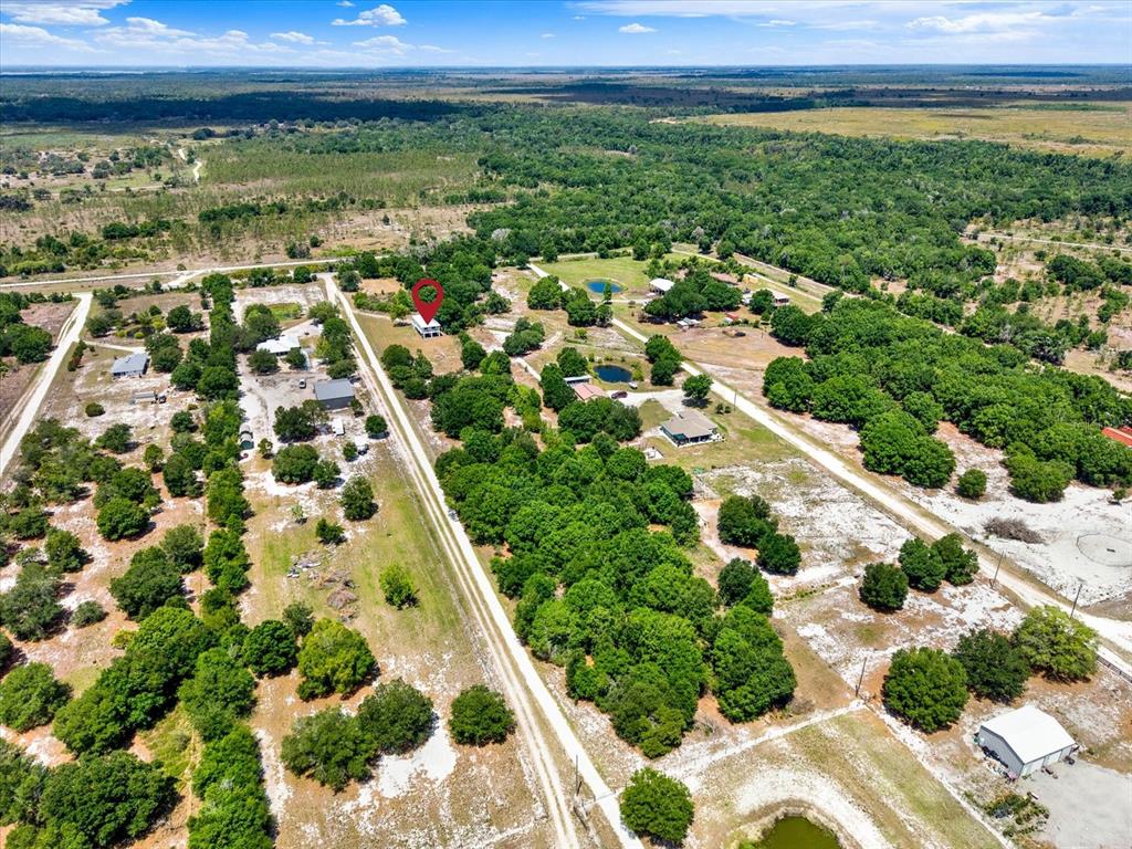 An aerial view shows a rural property with a house marked by a red pin — 464 LOGUE ROAD, MYAKKA CITY, FL
