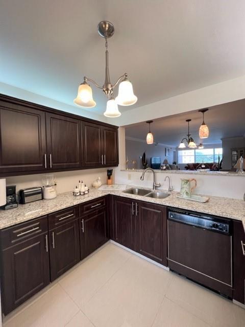 A kitchen features dark wood cabinets, granite countertops, and a stainless steel dishwasher — 2603 NW 103rd Avenue, Sunrise FL 33322, SUNRISE, FL