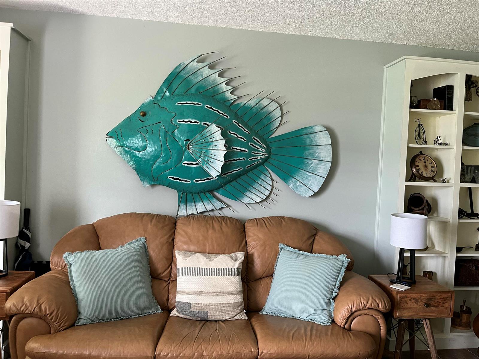 A living room features a leather sofa, a recliner, a glass coffee table, and wall decor — 915 Riverwood Lane, Jupiter FL 33458, JUPITER, FL