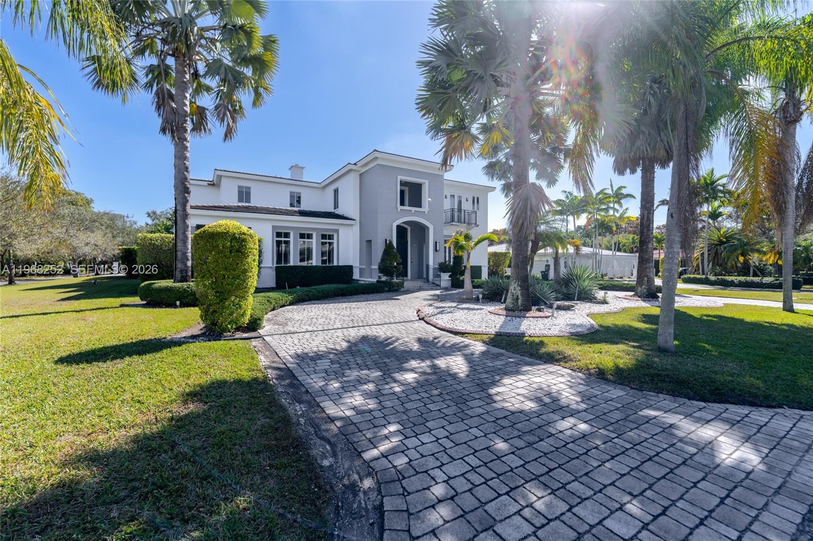 A two-story house with a paved driveway and palm trees in the front yard — 12755 SW 57th Ave, Coral Gables FL 33156, CORAL GABLES, FL