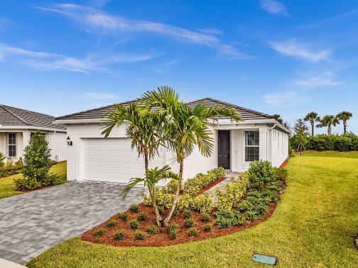 A single-story white house with a paved driveway, palm tree, and landscaped front yard — 1133 Haven Circle, Vero Beach FL 32960, VERO BEACH, FL