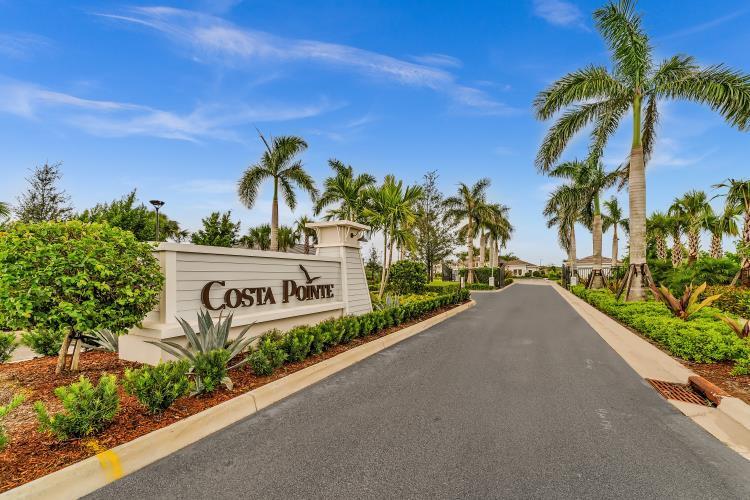 The entrance sign for the Costa Pointe community features palm trees and a paved road — 1133 Haven Circle, Vero Beach FL 32960, VERO BEACH, FL