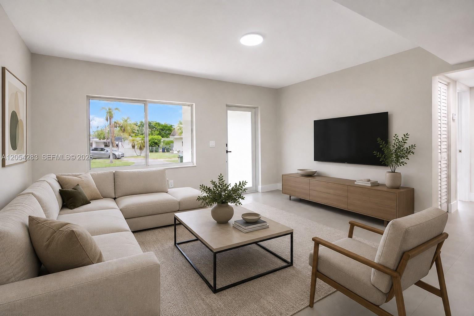A modern living room features a beige sectional sofa, a wooden media console, and a rug — 6410 SW 17th St, West Miami FL 33155, WEST MIAMI, FL