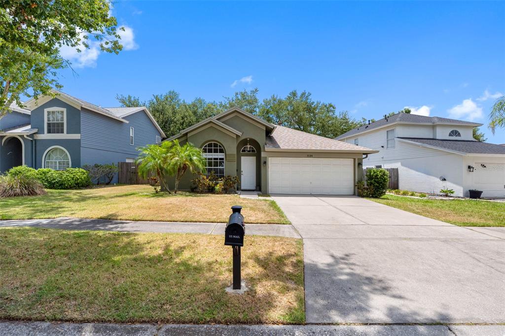 A single-story house with a green exterior, a two-car garage, and a front lawn — 1534 SCOTCH PINE DRIVE, BRANDON, FL