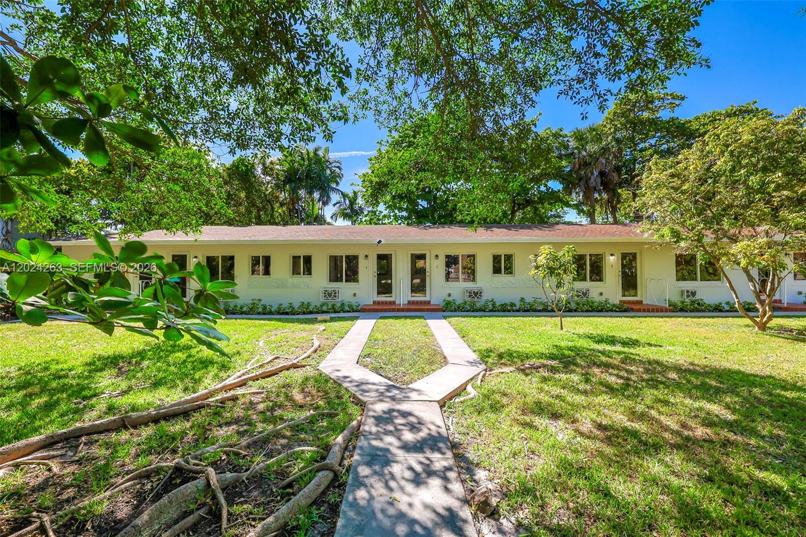 A single-story apartment building with a Y-shaped concrete walkway leading to the front doors — 8440 NE 1st Ave # 5, Miami FL 33138, MIAMI, FL