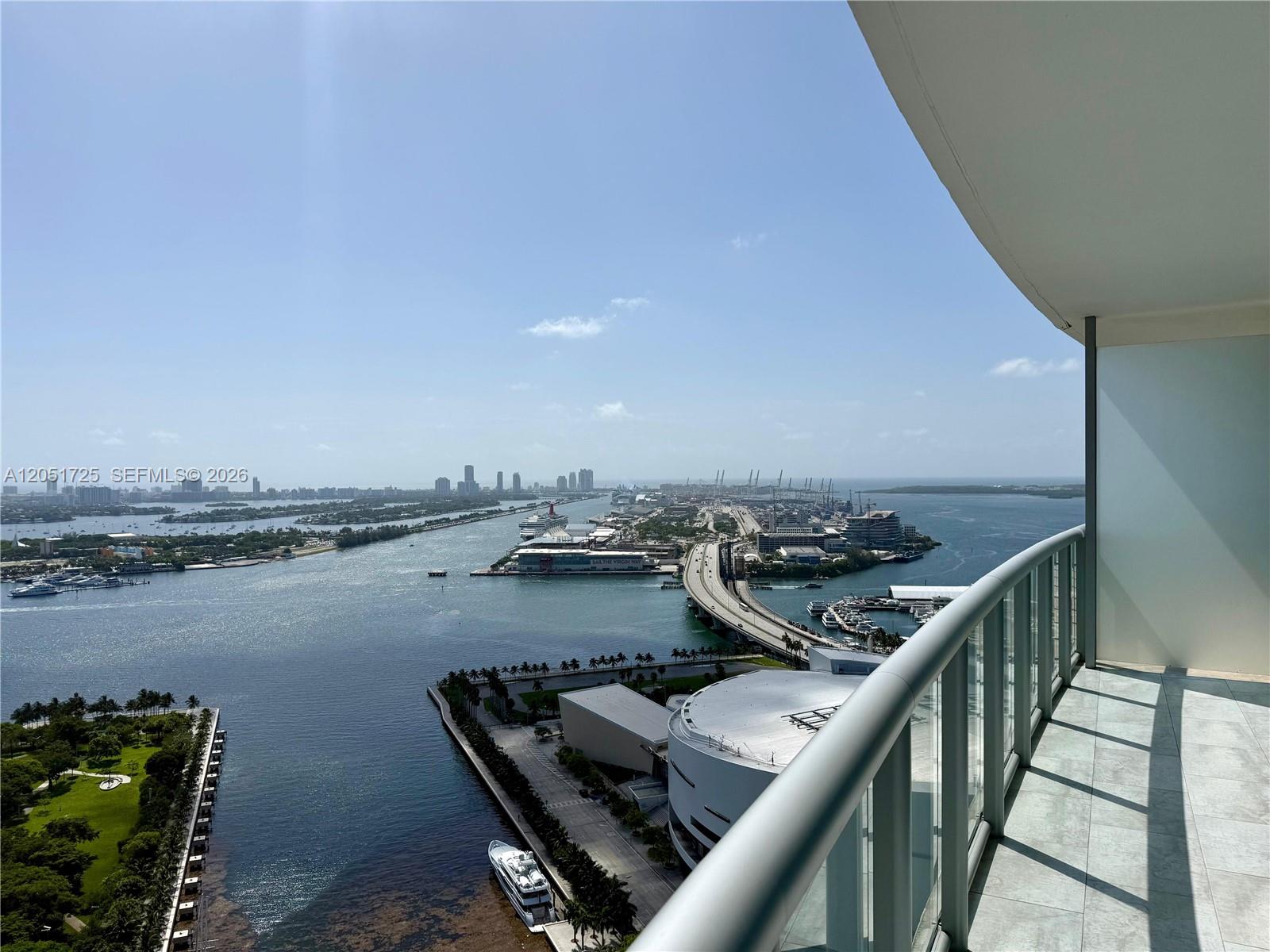 A high-rise balcony overlooks a bay, a bridge, and a cruise ship terminal — 888 Biscayne Blvd # 3611, Miami FL 33132, MIAMI, FL