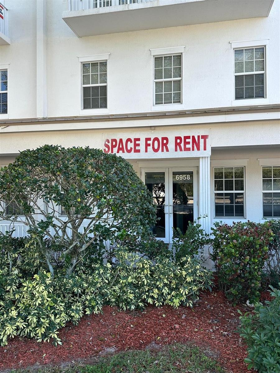 A white building exterior features a glass door entrance with a space for rent sign — 6958 Griffin Road # 9, Davie FL 33314, DAVIE, FL