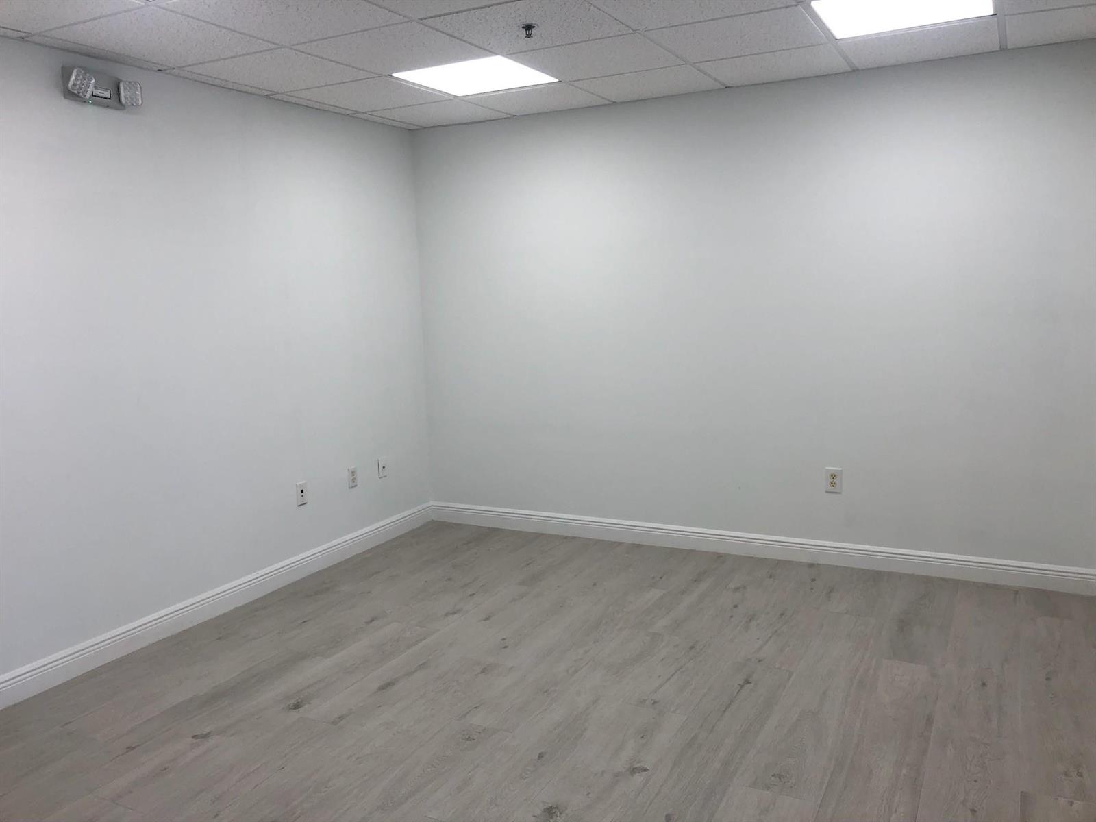 An empty office room features white walls, light wood-look flooring, and a drop ceiling — 6958 Griffin Road # 9, Davie FL 33314, DAVIE, FL