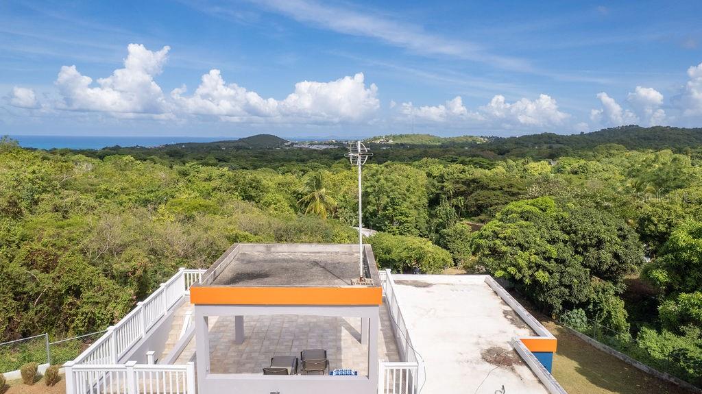 An elevated view of a flat rooftop terrace with a covered seating area and antenna — 78 HIDDEN PARADISE, VIEQUES, PR