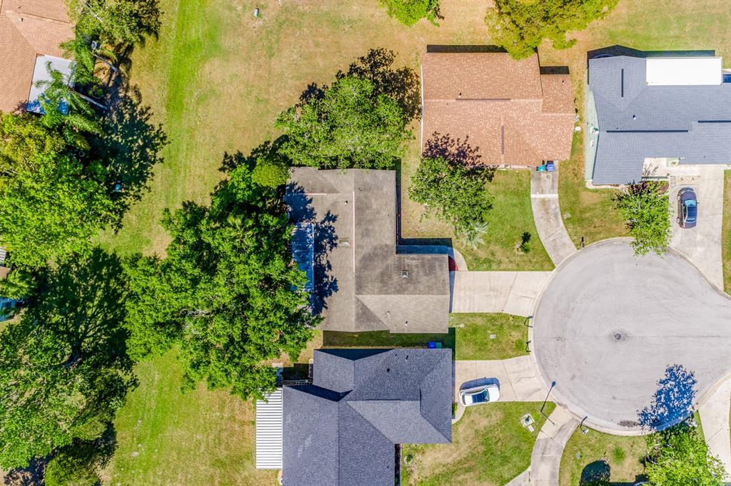 An aerial view shows two adjacent houses with dark roofs and driveways in a neighborhood — 10330 LICORICE WAY, ORLANDO, FL