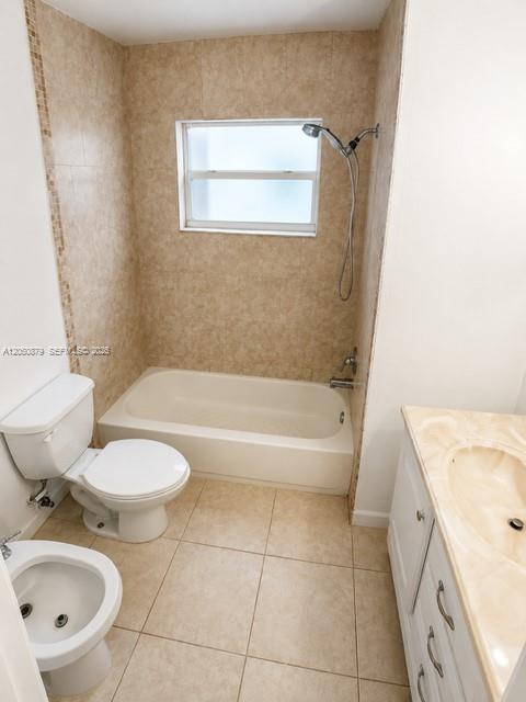 A bathroom features a white toilet, a bidet, a bathtub with a shower, and a vanity — 5373 W 24th Ct # 5373, Hialeah FL 33016, HIALEAH, FL