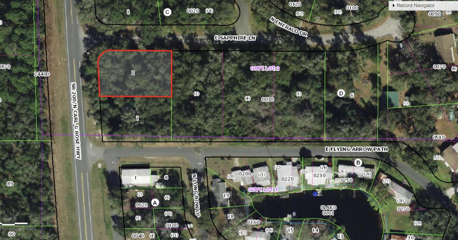This is an aerial map showing a wooded lot highlighted in red near a highway — 4975 N Carl G Rose Highway, FL 34442, FL
