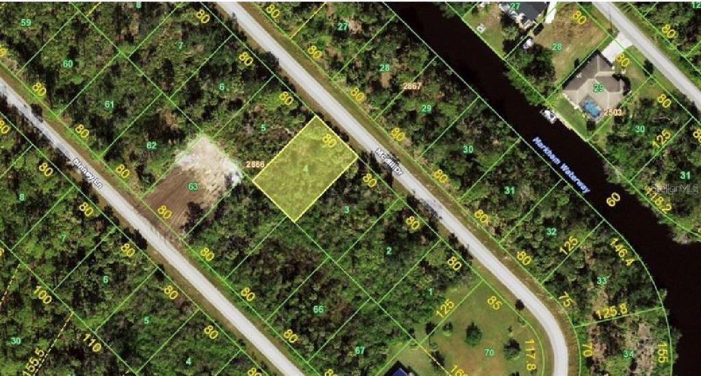 This is an aerial map showing a highlighted vacant residential lot among wooded properties — 523 MCDILL DRIVE, PORT CHARLOTTE, FL
