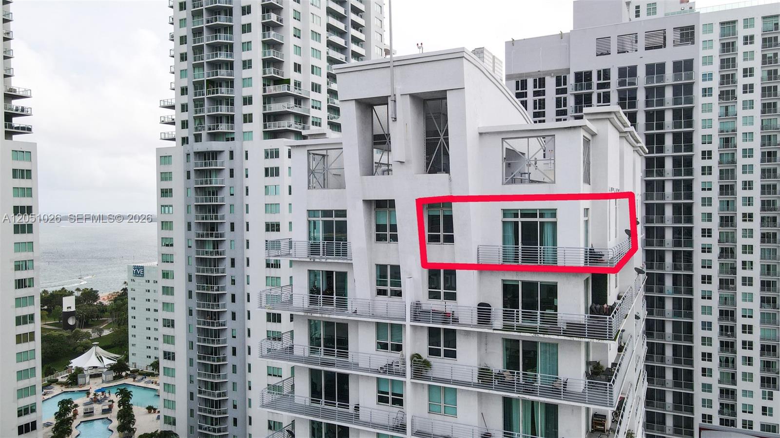 An exterior view of a high-rise building with a red rectangle highlighting a balcony unit — 234 NE 3rd St, Miami FL 33132, MIAMI, FL