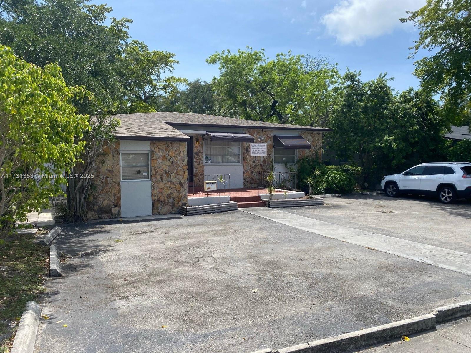 A single-story building with a stone facade and a paved parking lot in front — 307 S 24th Ave, Hollywood FL 33020, HOLLYWOOD, FL