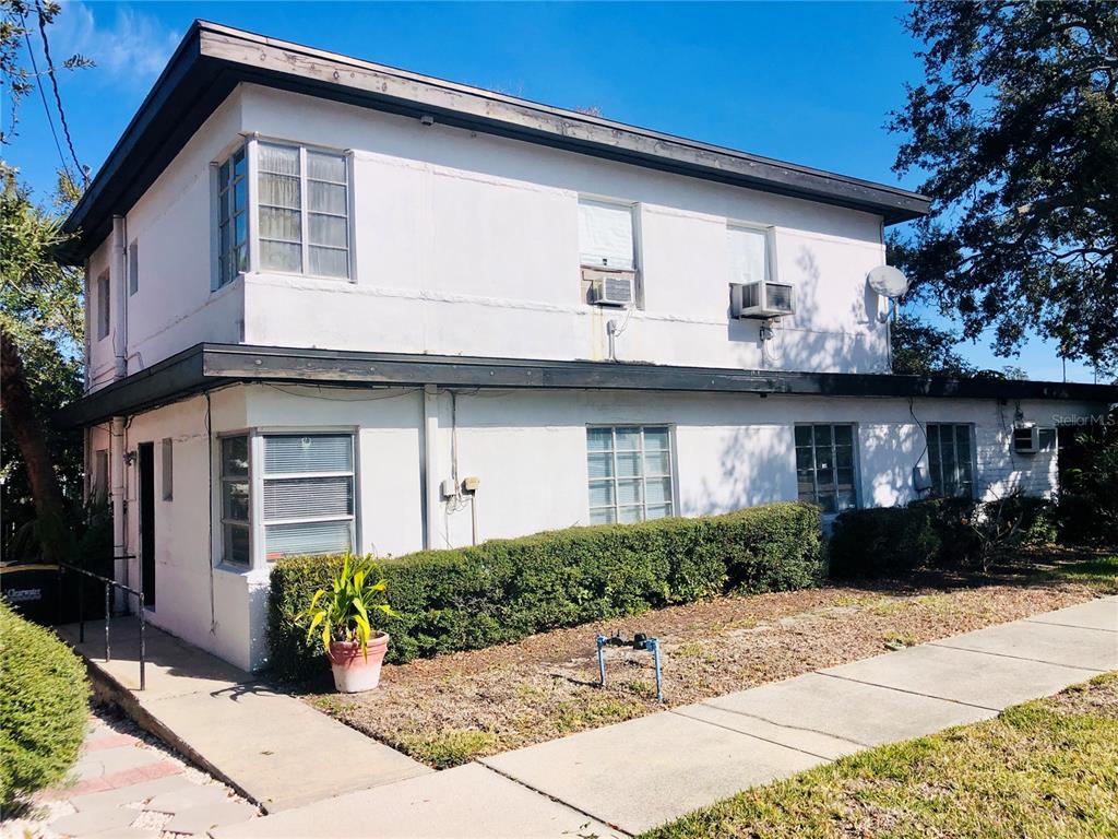 A two-story white stucco building with a flat roof and multiple window units — 1762 N FORT HARRISON AVENUE, CLEARWATER, FL