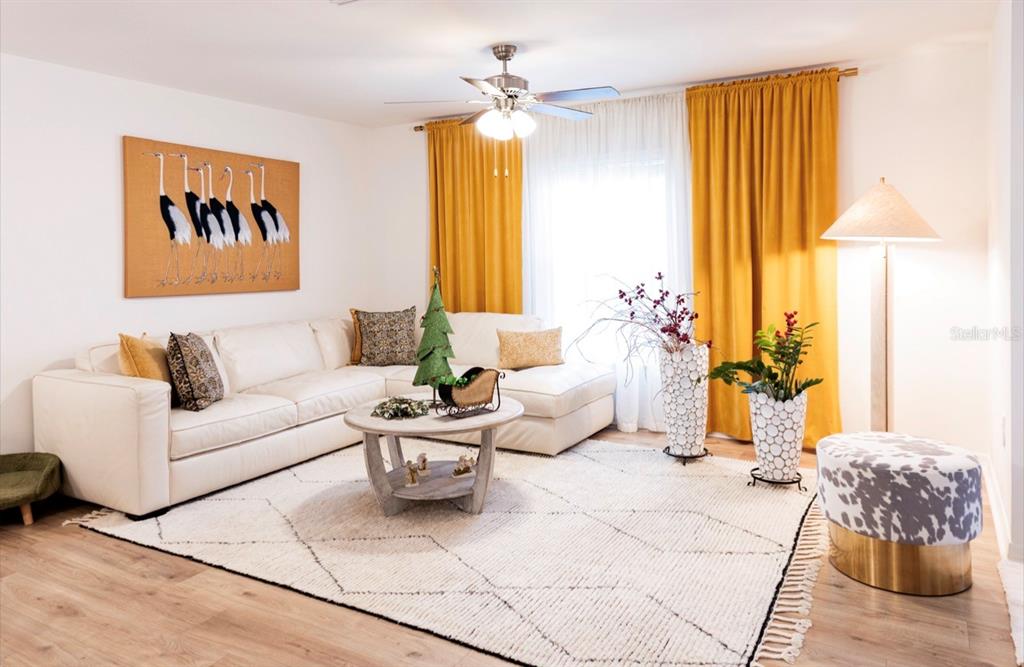 A living room features a white sectional sofa, a round coffee table, and yellow curtains — 1660 LANSDALE AVENUE, NORTH PORT, FL