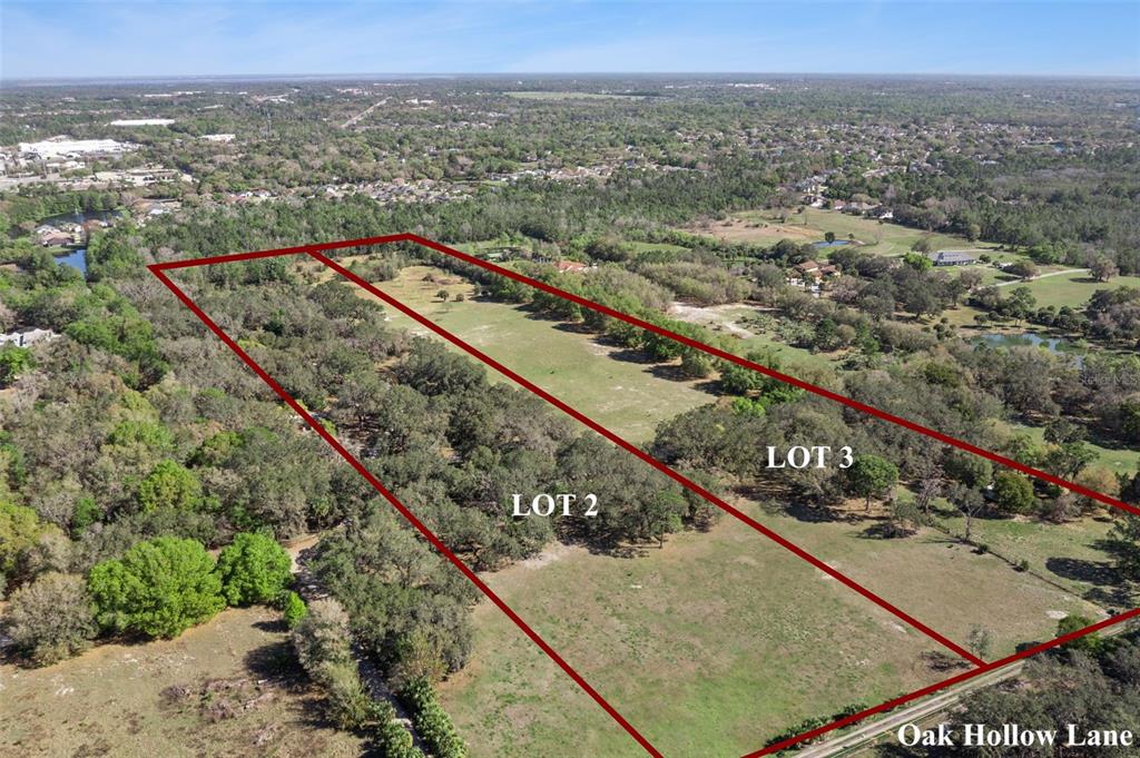 An aerial view shows two adjacent rectangular lots of land bordered by trees and grass — LOT 3 OAK HOLLOW, OVIEDO, FL