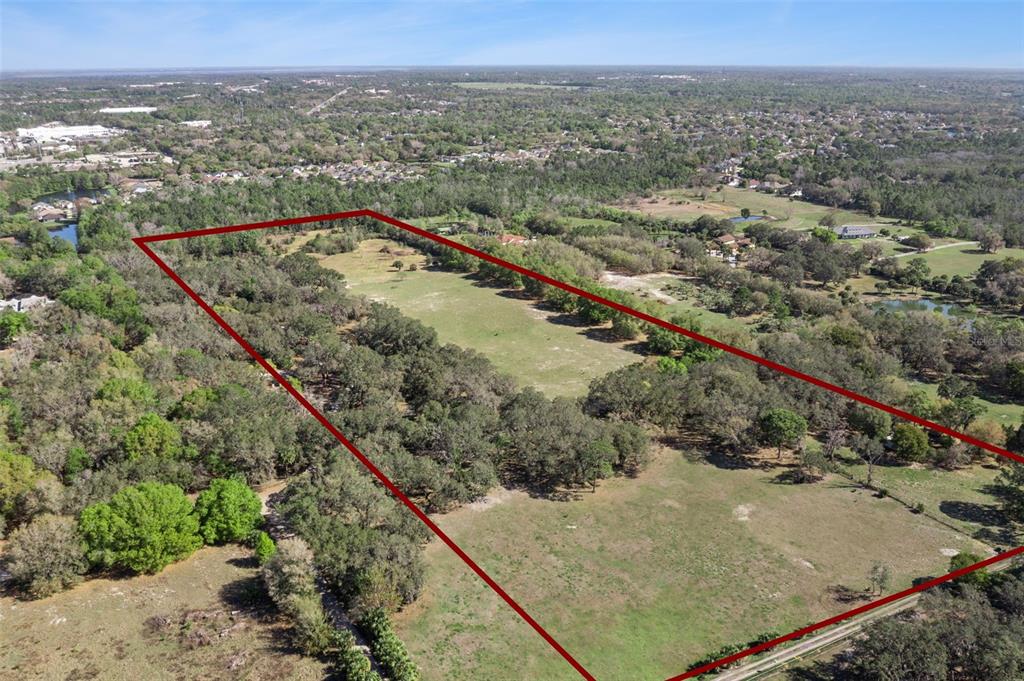 An aerial view shows a large, rectangular plot of land outlined in red — LOT 3 OAK HOLLOW, OVIEDO, FL