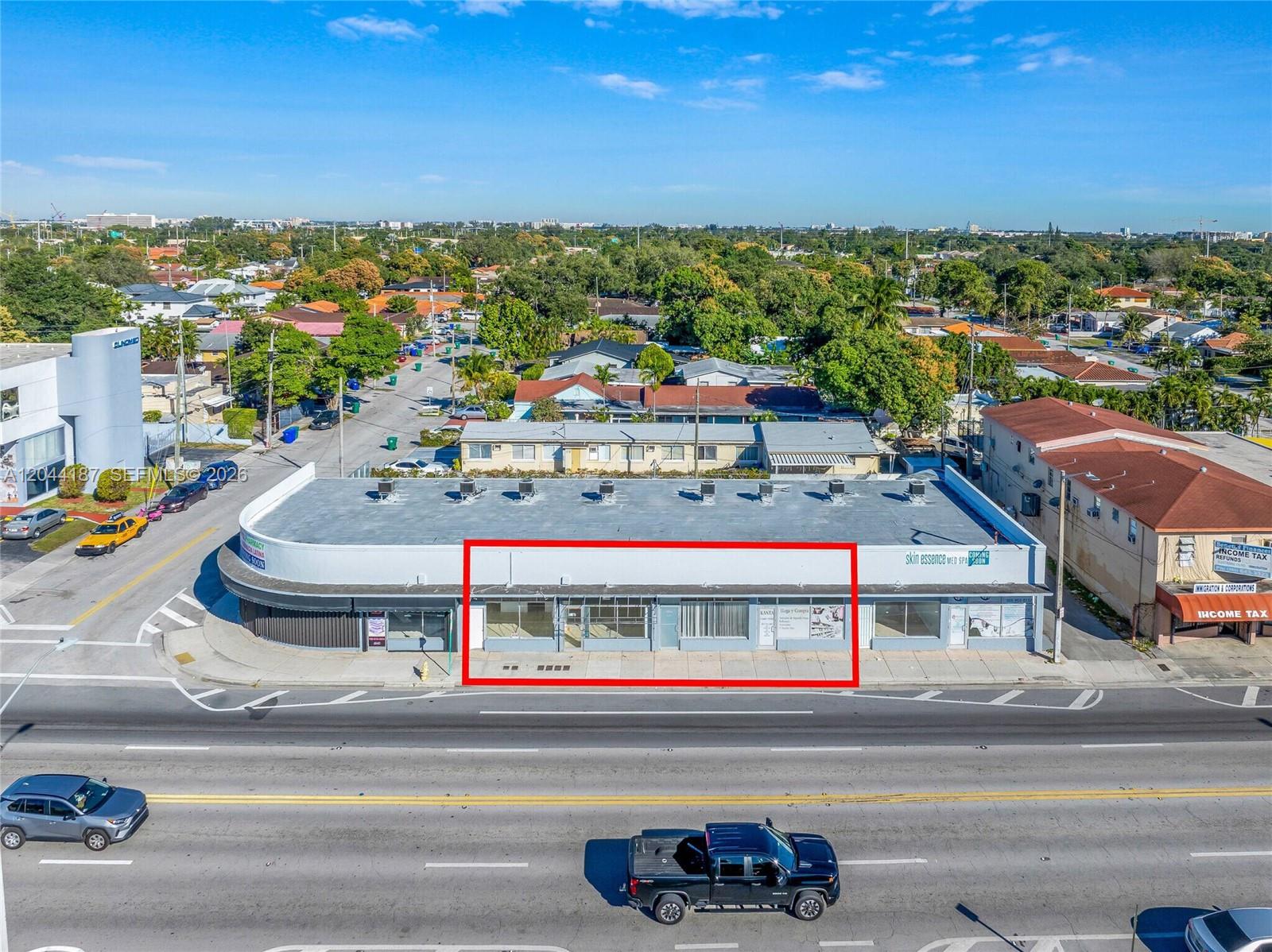 An aerial view shows a commercial strip mall building with a red-outlined vacant storefront — 3241 NW 7th St # 3251, Miami FL 33125, MIAMI, FL