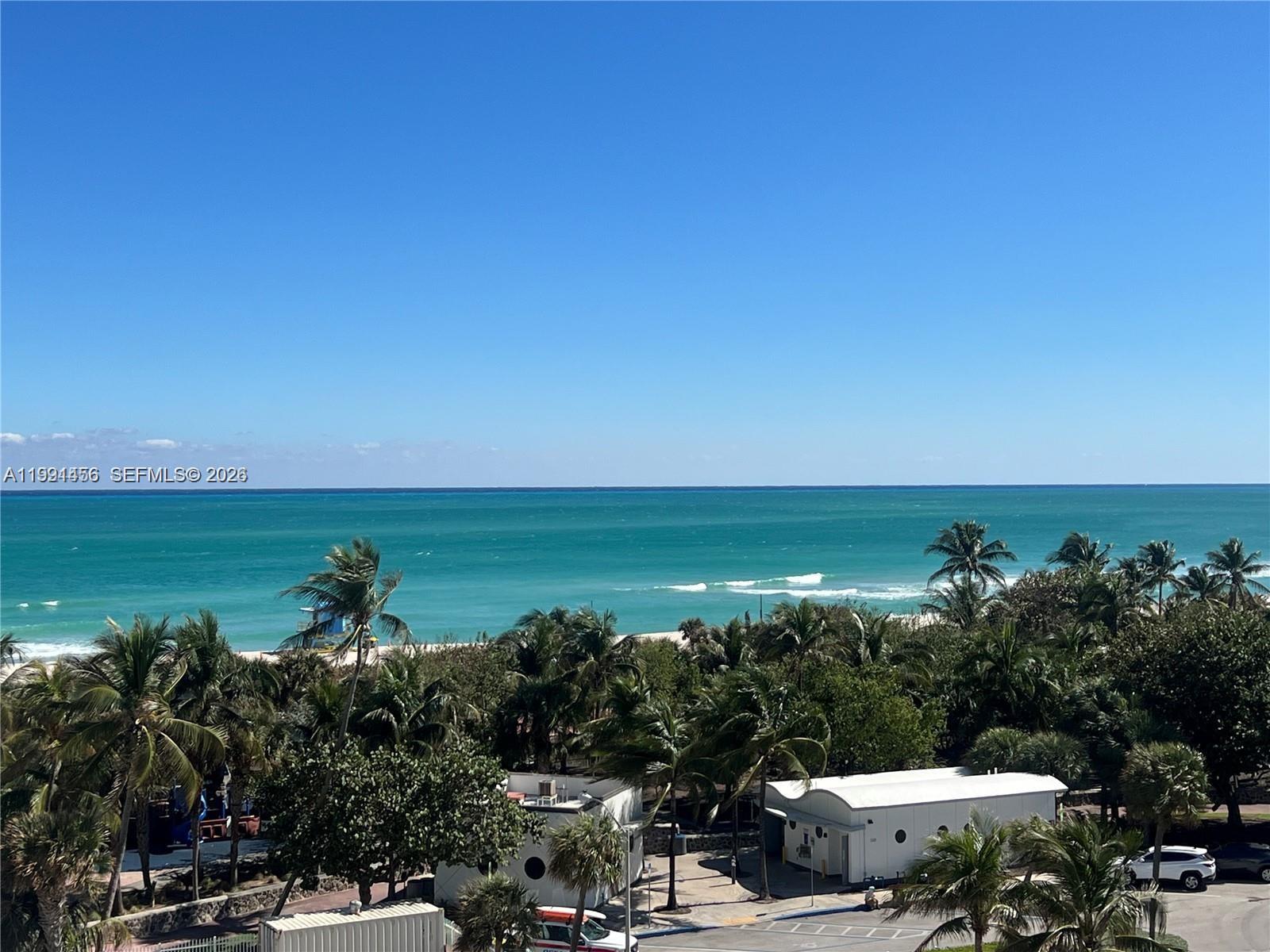 An elevated view shows a beach with palm trees, a small building, and the ocean — 5313 Collins Ave # 704, Miami Beach FL 33140, MIAMI BEACH, FL