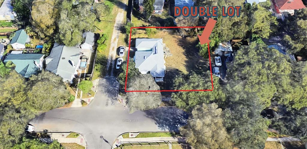 An aerial view shows a house situated on a double lot with surrounding trees — 545 15TH AVENUE S, ST PETERSBURG, FL