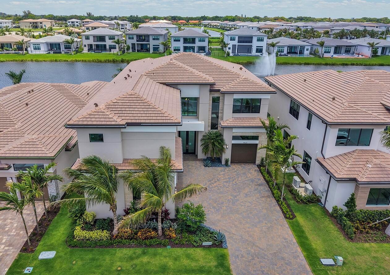 An aerial view shows a two-story house with a tiled roof, driveway, and palm trees — 9523 Riverside Park Drive, Boca Raton FL 33434, BOCA RATON, FL