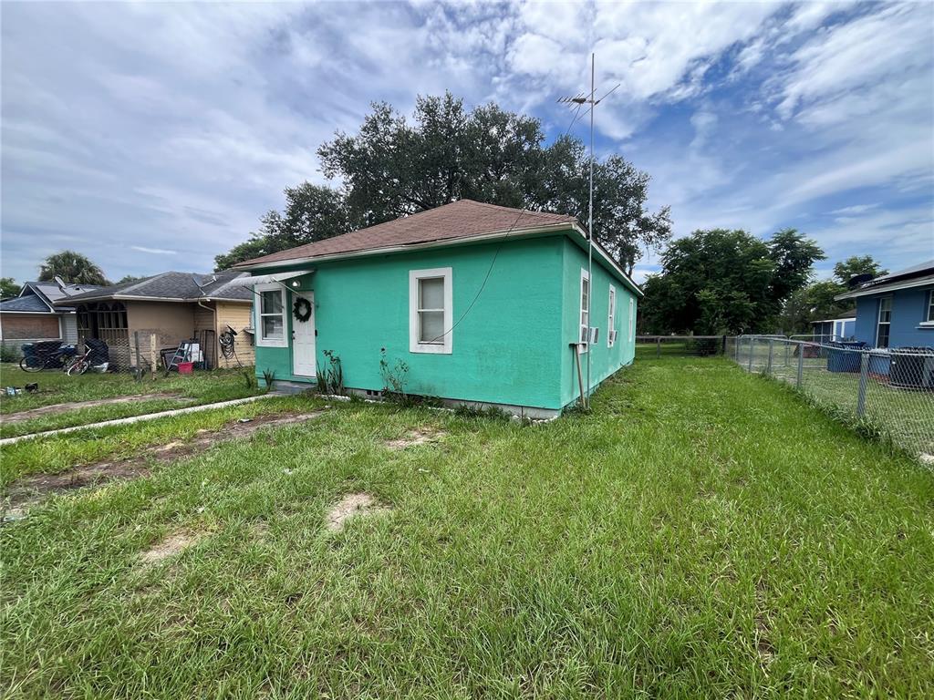 A bright green, single-story house with a hip roof stands on a grassy lot — 33 W JOHNSON AVENUE, LAKE WALES, FL