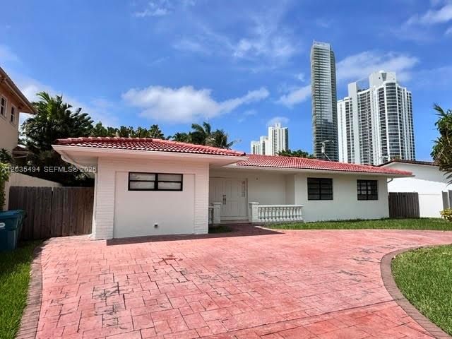 A single-story house with a red-tiled roof and a stamped concrete driveway — 215 187th St, Sunny Isles Beach FL 33160, SUNNY ISLES BEACH, FL