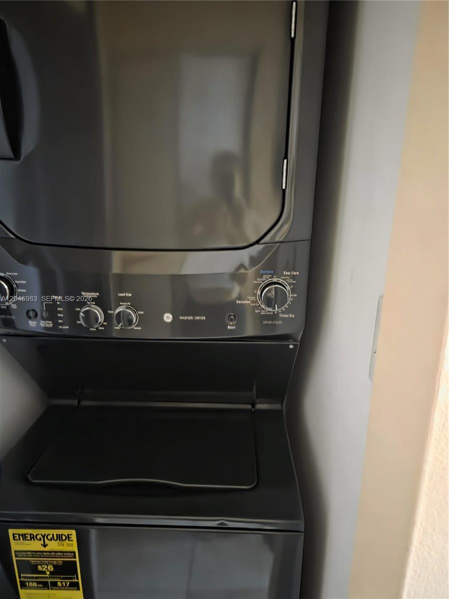 A stacked GE washer and dryer unit is installed in a small laundry closet — 520 S Park Rd # 12, Hollywood FL 33021, HOLLYWOOD, FL
