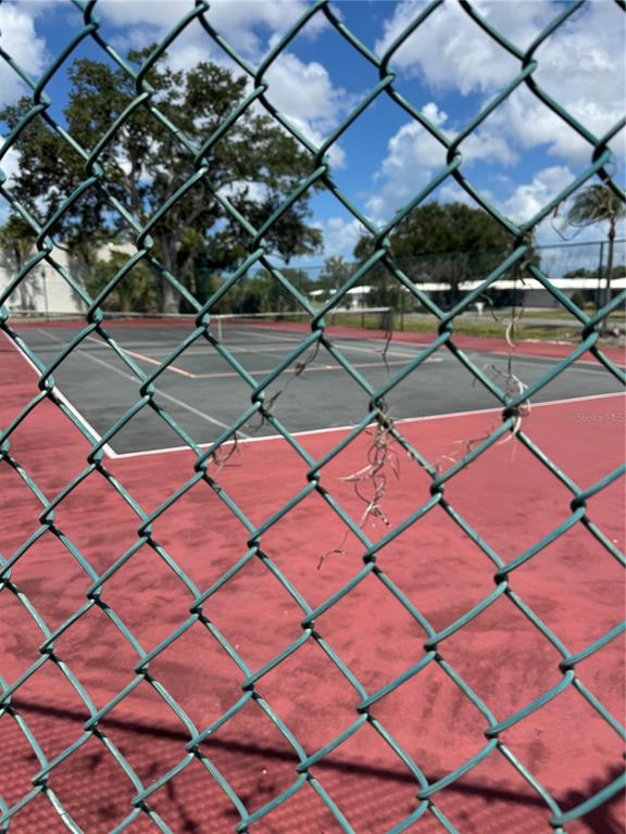 A view of a tennis court through a chain-link fence — 3217 BENEVA ROAD UNIT 202, SARASOTA, FL
