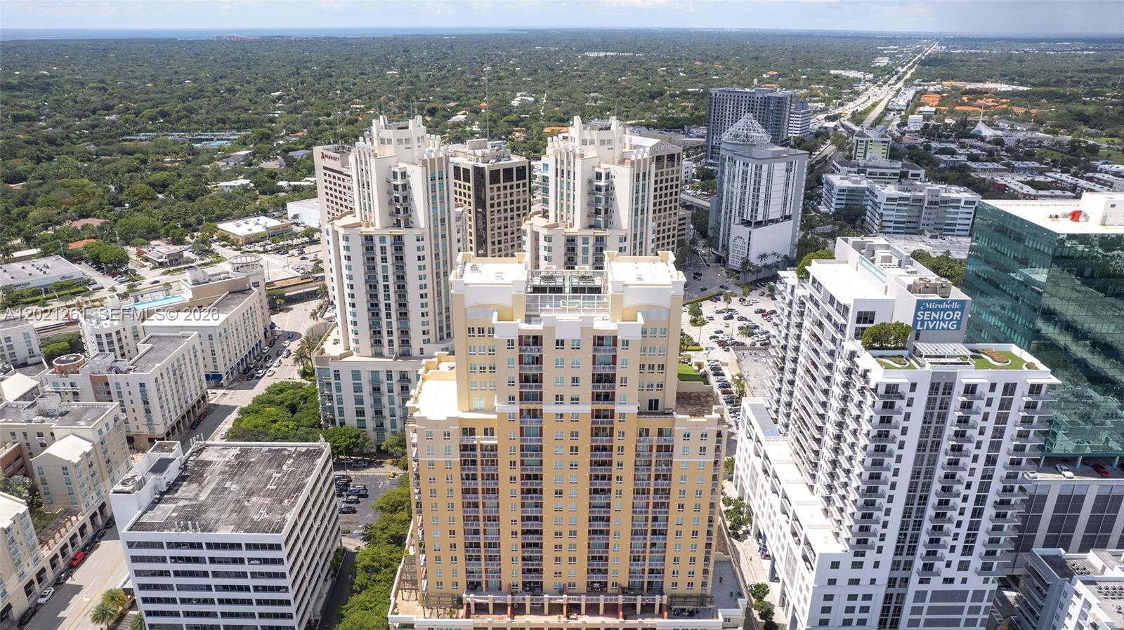 An aerial view shows several high-rise residential and commercial buildings in a dense urban area — 7350 SW 89th St # 1410S, Miami FL 33156, MIAMI, FL