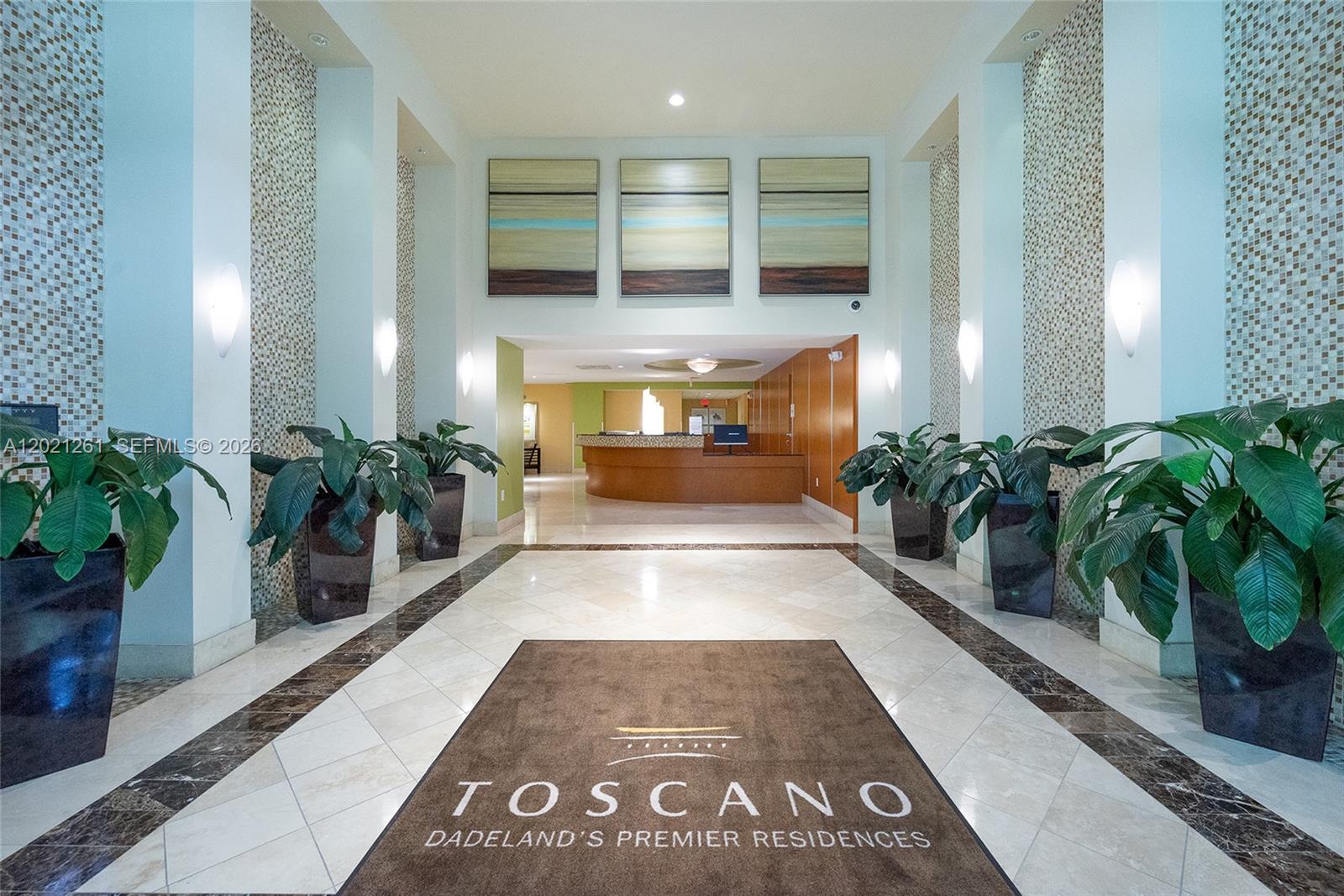 A lobby features a reception desk, tiled floors, potted plants, and wall art — 7350 SW 89th St # 1410S, Miami FL 33156, MIAMI, FL