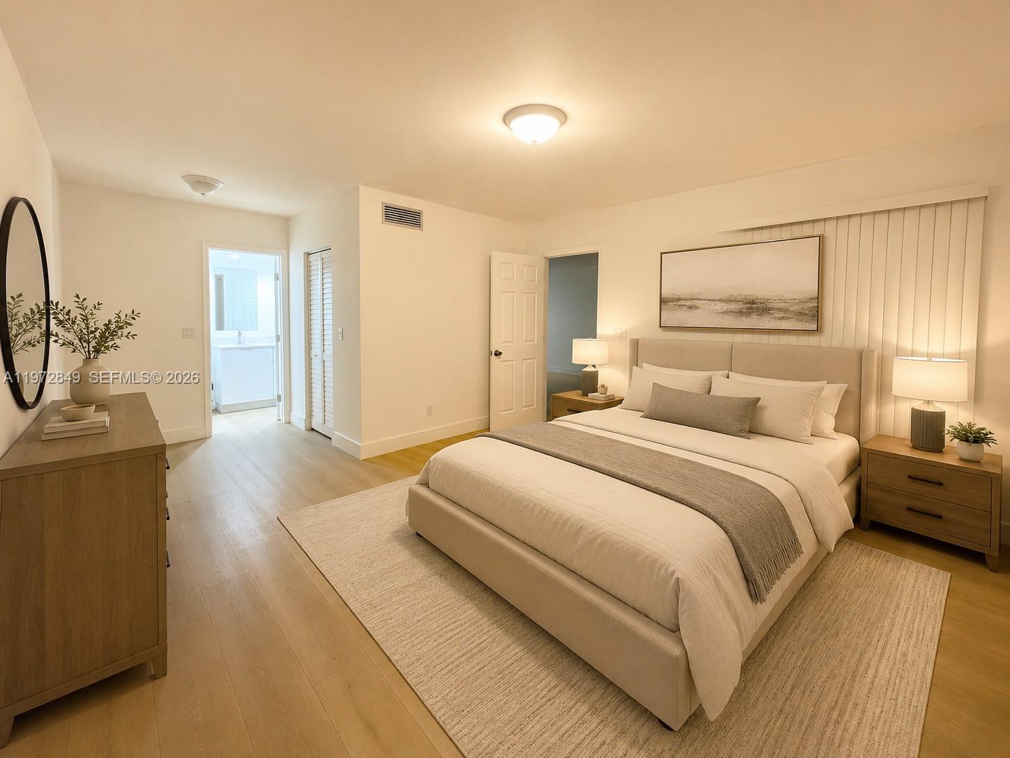A bedroom features a bed, two nightstands, a dresser, and light-colored wood flooring — 1765 Courtyard way # 103, Naples FL 33114, NAPLES, FL