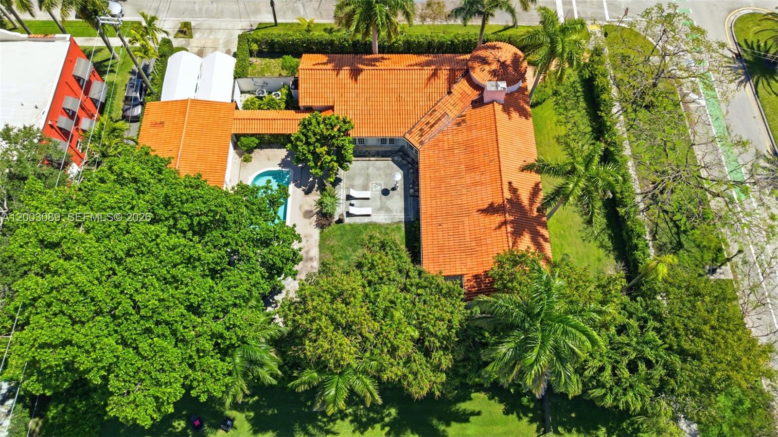 An aerial view shows a house with an orange tile roof, pool, and surrounding trees — 2300 S Miami Ave, Miami FL 33129, MIAMI, FL