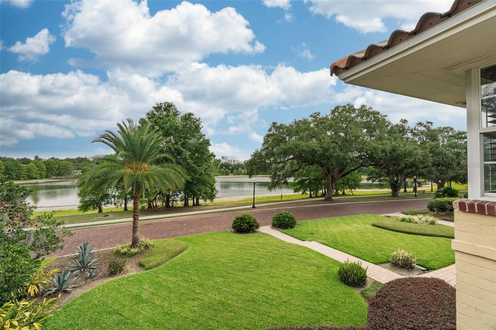 A view from a house overlooking a brick street, a grassy lawn, and a lake — 830 LAKE DAVIS DRIVE, ORLANDO, FL