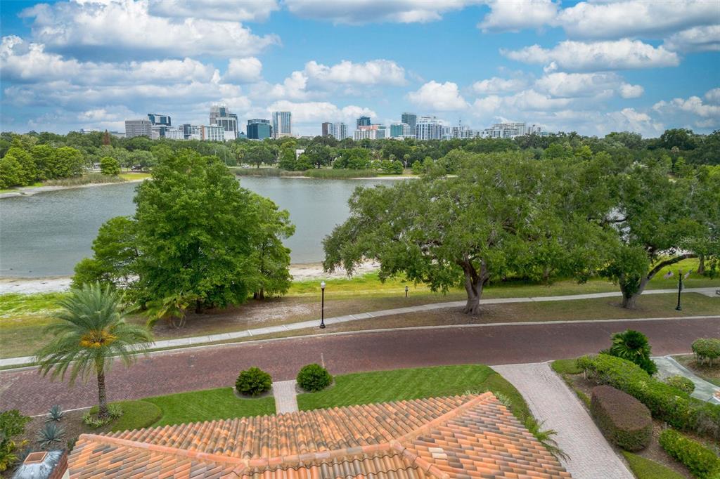 An elevated view of a lake and city skyline from a tiled roof terrace — 830 LAKE DAVIS DRIVE, ORLANDO, FL