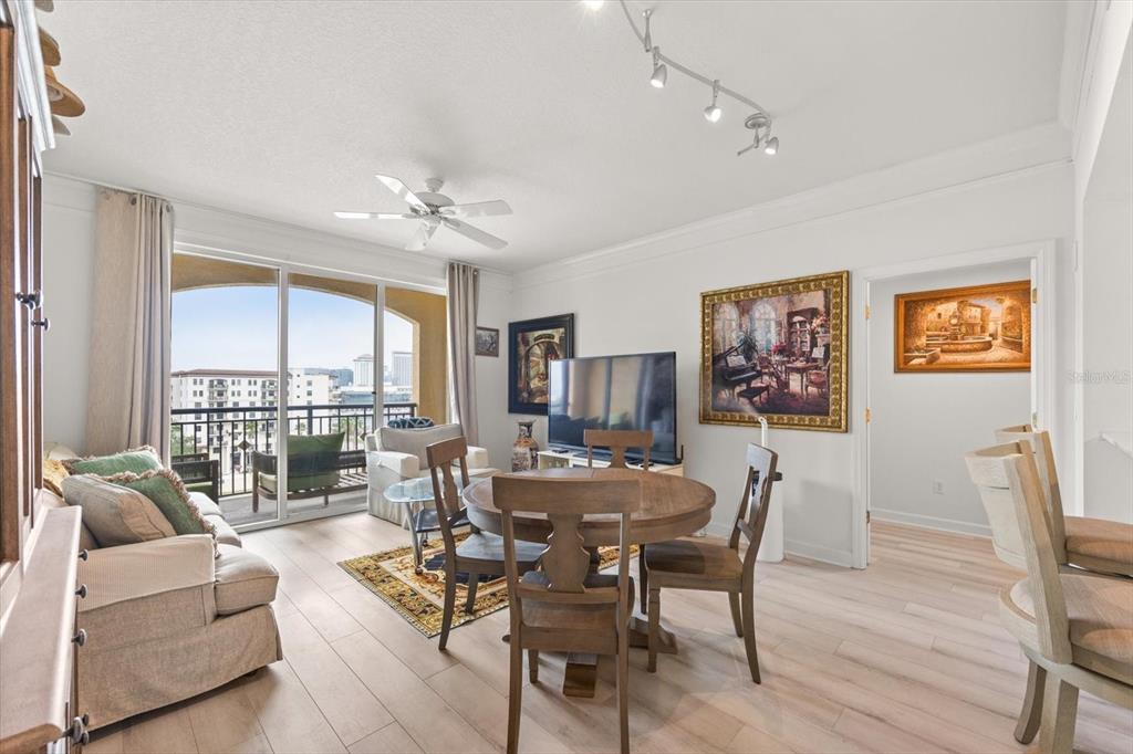 A living and dining area features light wood flooring, a ceiling fan, and a balcony — 345 BAYSHORE BOULEVARD UNIT 706, TAMPA, FL