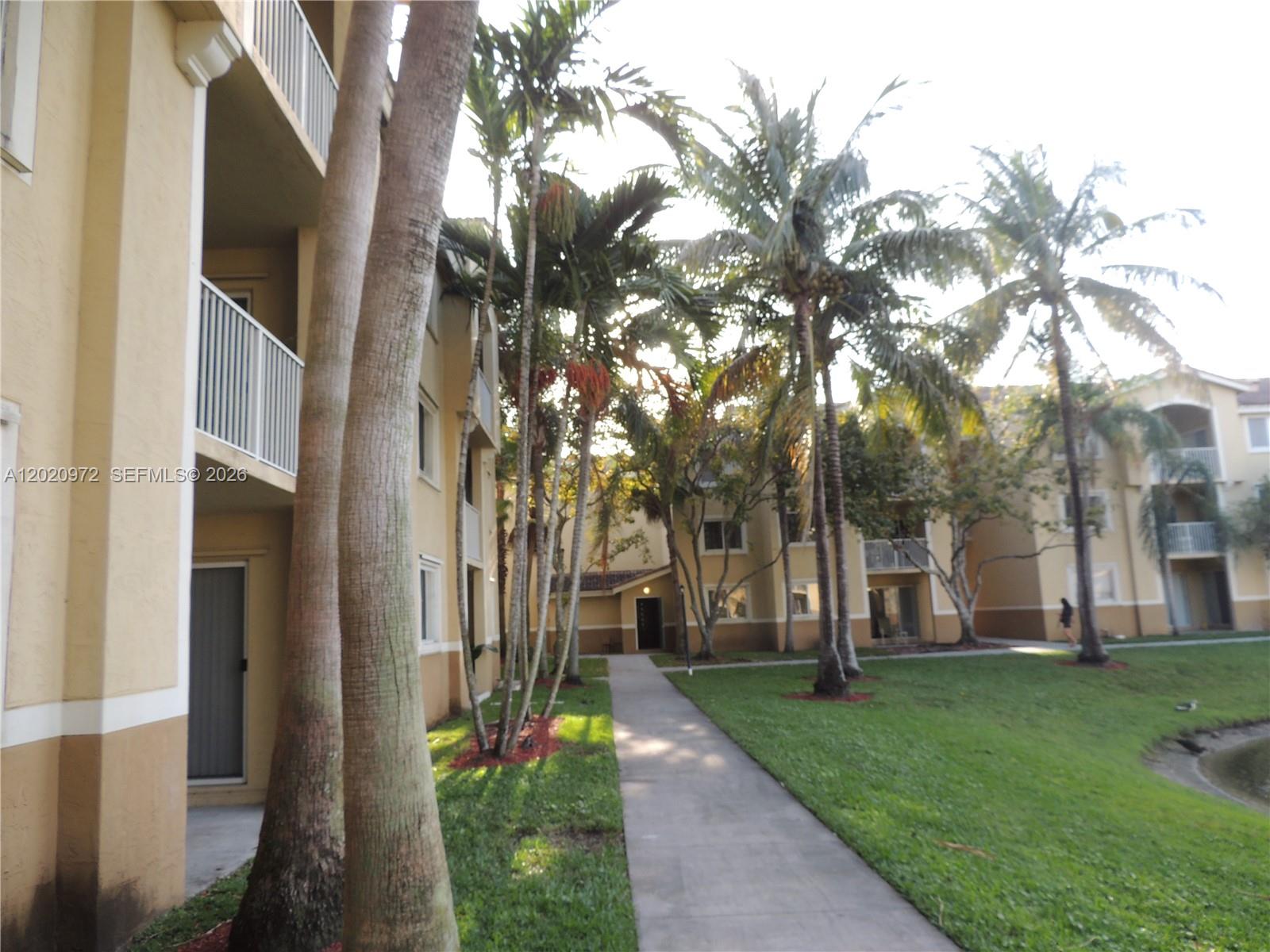 A stacked washer and dryer unit is located inside a small utility closet — 2600 S University Dr # 103, Davie FL 33328, DAVIE, FL