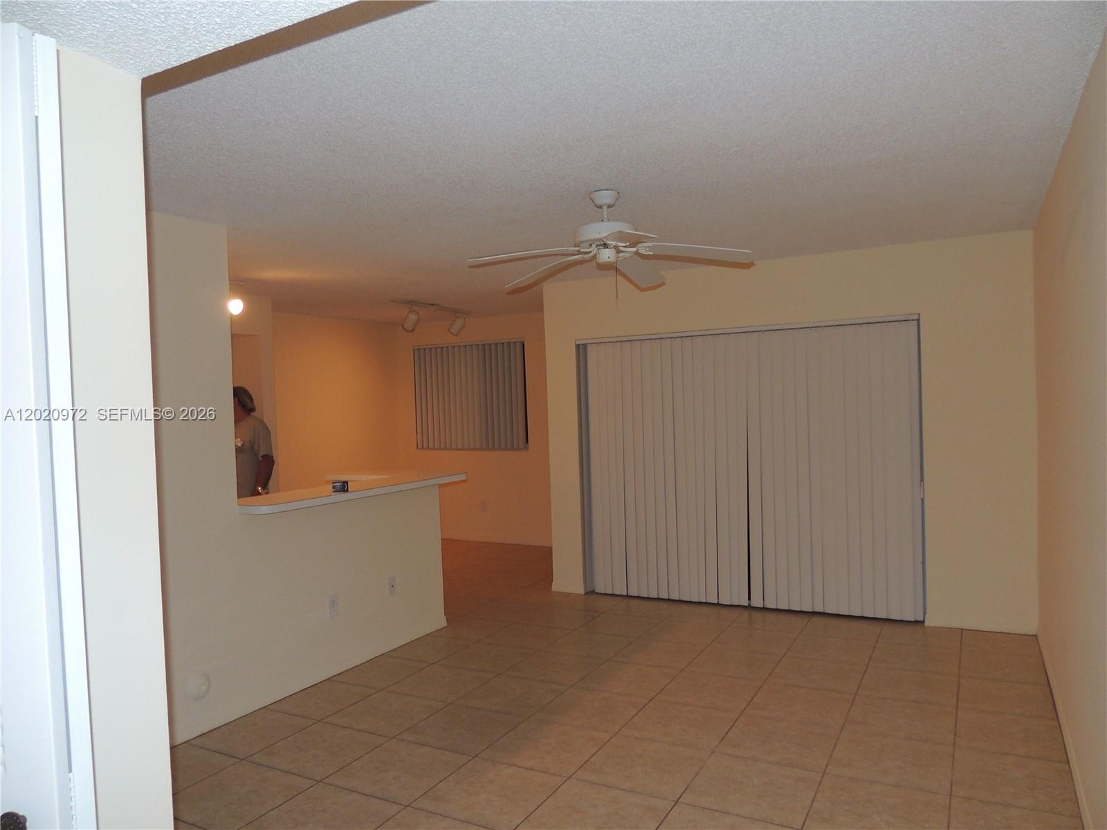 A closet with white louvered doors and a wire shelf is set into a wall — 2600 S University Dr # 103, Davie FL 33328, DAVIE, FL