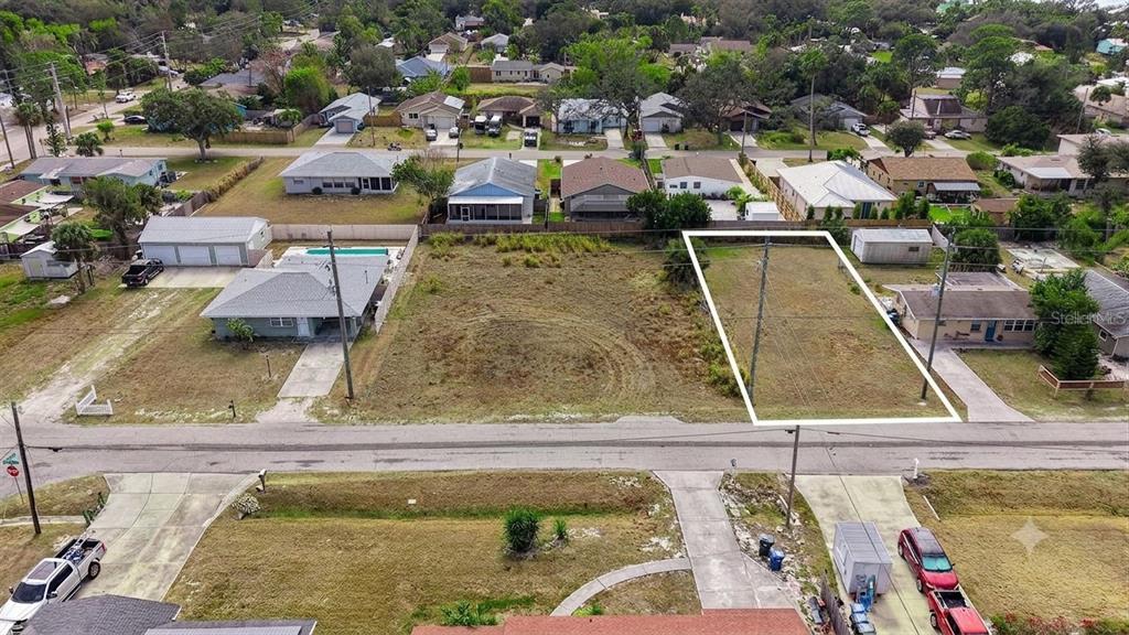 An aerial view shows a vacant rectangular lot outlined in white within a residential neighborhood — 0 (Lot 15) WHARF ROAD, SARASOTA, FL