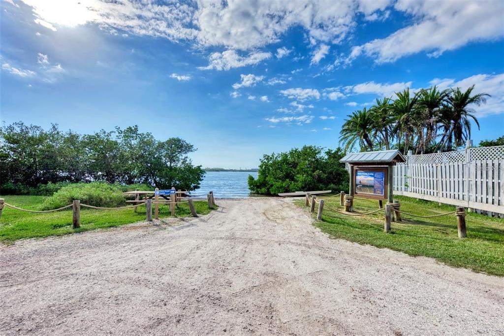 A gravel path leads to a waterfront boat launch area with picnic tables and palm trees — 0 (Lot 15) WHARF ROAD, SARASOTA, FL