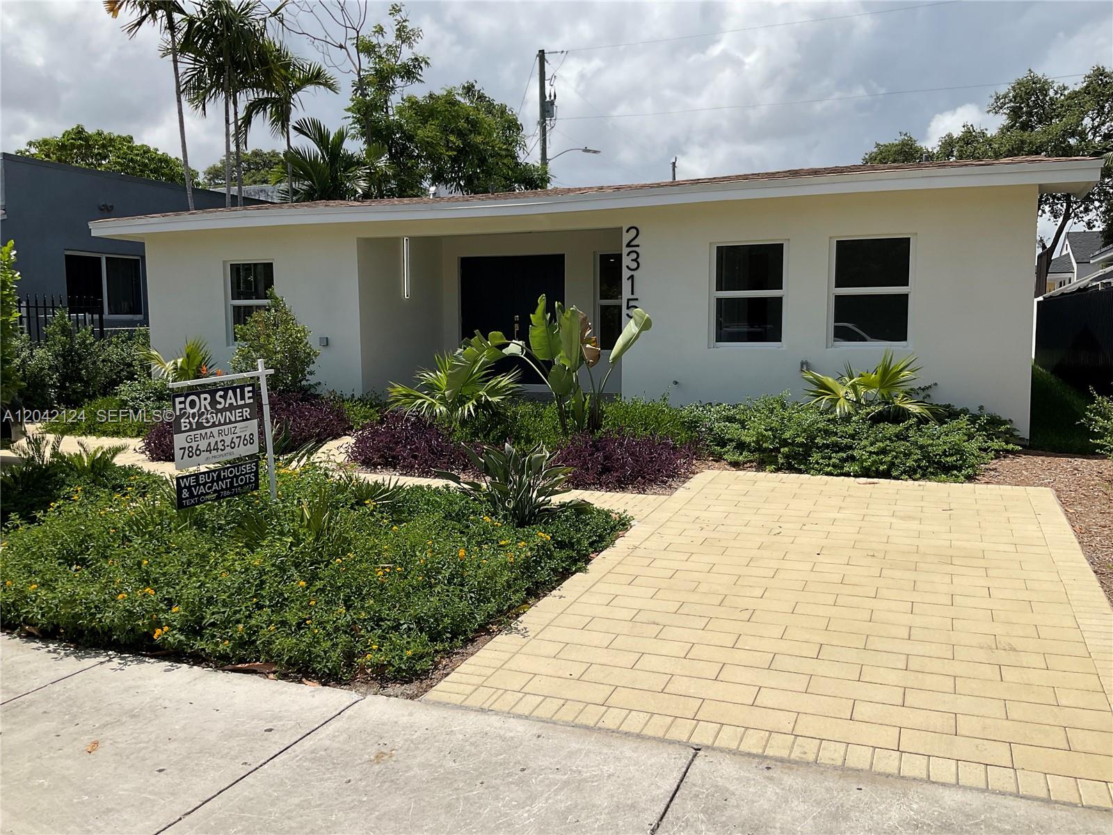 A single-story house with a paved driveway and a for sale sign in the yard — 2315 NW 3rd St, Miami FL 33125, MIAMI, FL