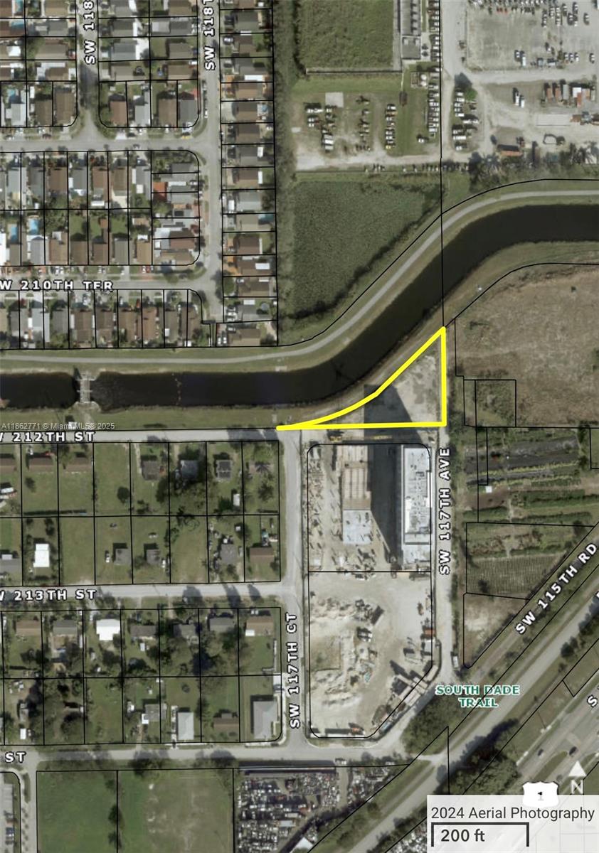This is an aerial map showing a triangular parcel of land highlighted in yellow — 21150 SW 117 AVE, Miami FL 33177, MIAMI, FL