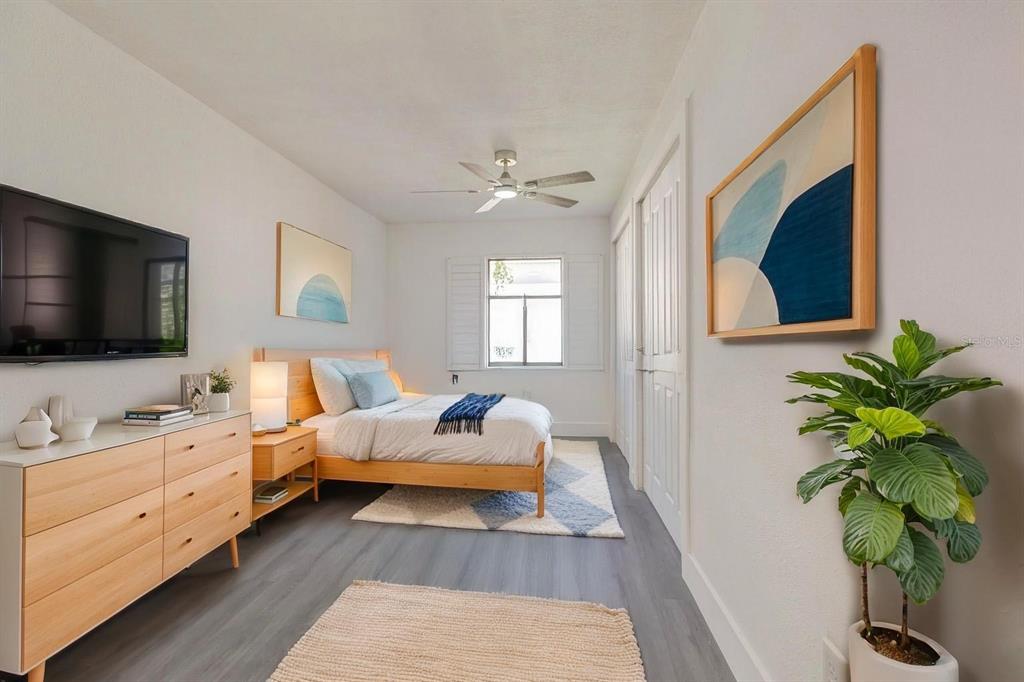 A bedroom features a light wood bed, a matching dresser, and a potted plant — 2261 S FLAGLER AVENUE, FLAGLER BEACH, FL