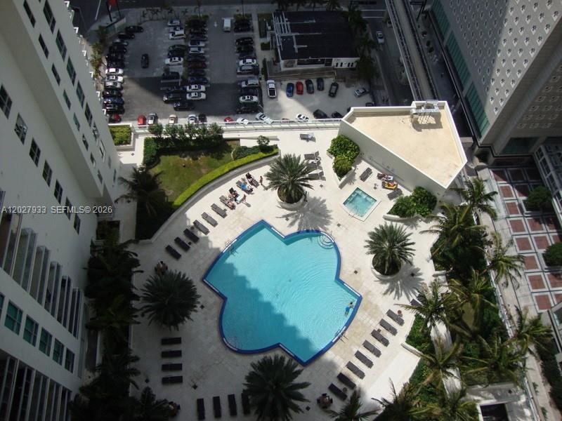 An aerial view shows a clover-shaped swimming pool surrounded by lounge chairs and palm trees — 300 S Biscayne Blvd # 2909, Miami FL 33131, MIAMI, FL