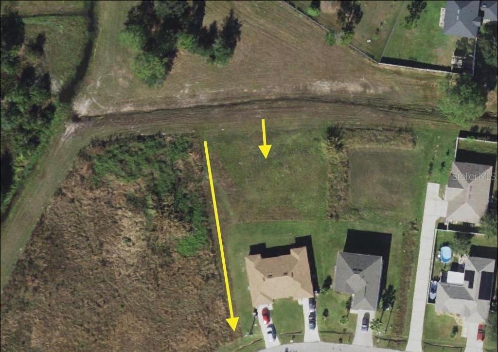 An aerial view shows a vacant residential lot situated next to existing houses — 0 HERALDO COURT, KISSIMMEE, FL