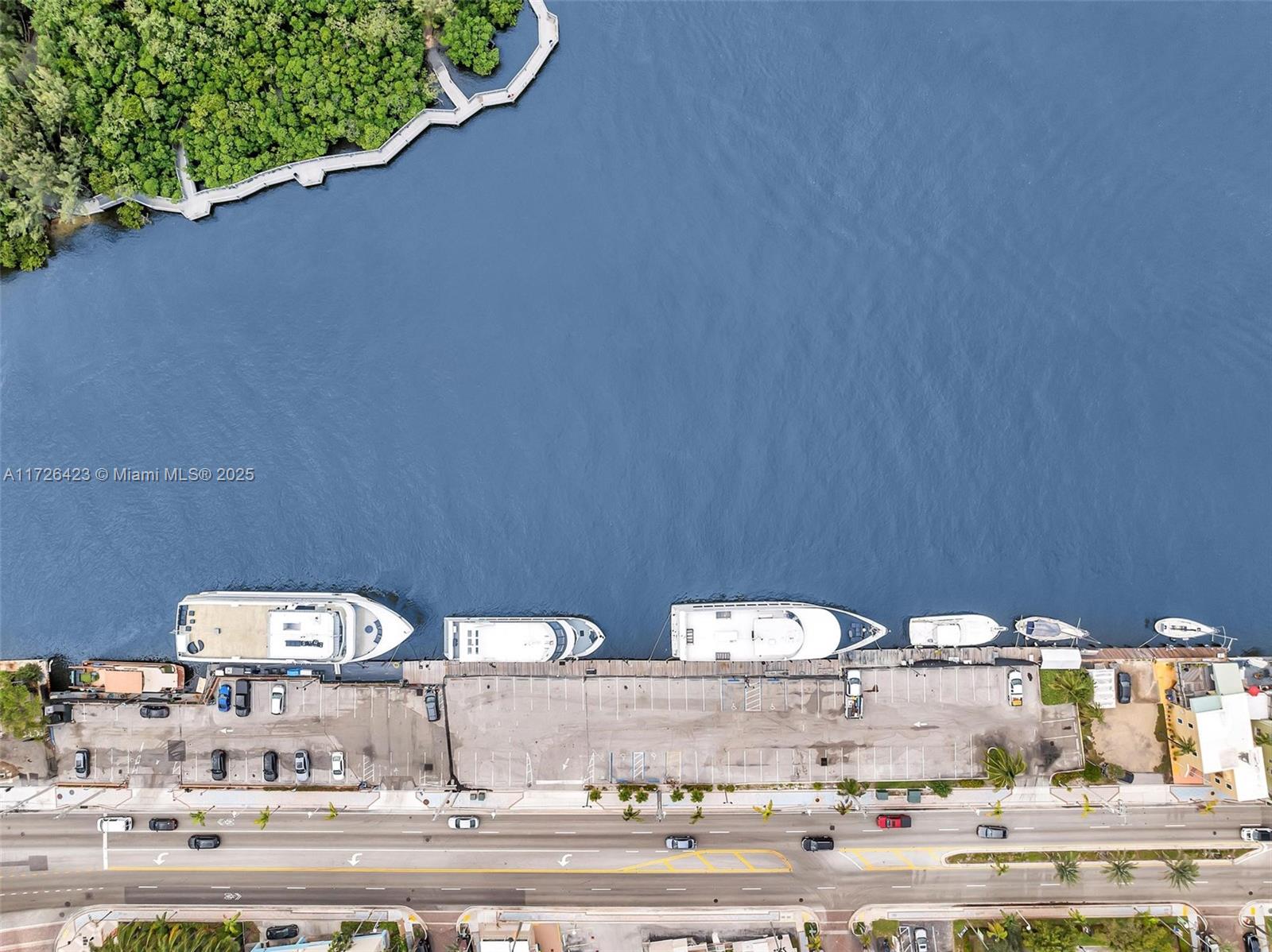 An aerial view shows a parking lot adjacent to a waterway with several docked yachts — 1318 N Ocean Dr, Hollywood FL 33019, HOLLYWOOD, FL
